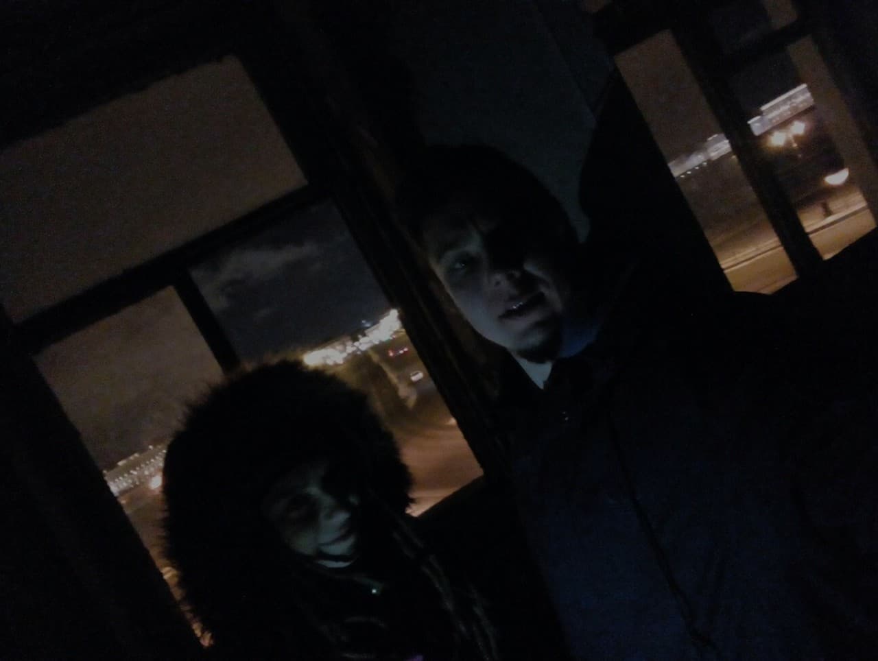 Two silhouettes — Anton Kolhonen and his acquaintance Masha — take a selfie inside an abandoned building on Vasilyevsky Island.